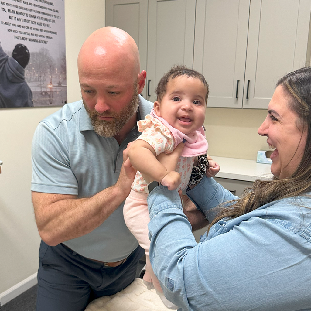 Dr Eric Chludzinski giving a baby chiropractic care
