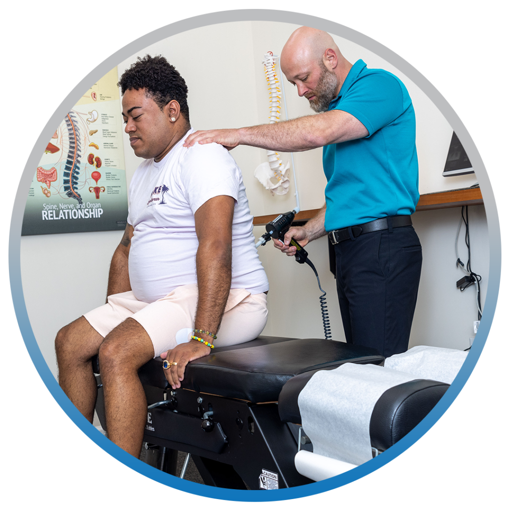 Dr. Eric Chludzinski treating patients back pain