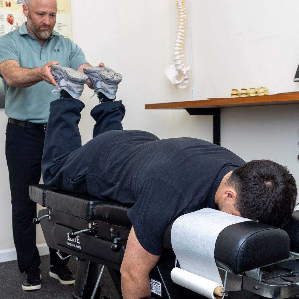 Dr Eric Chludzinski giving patient poor posture treatment