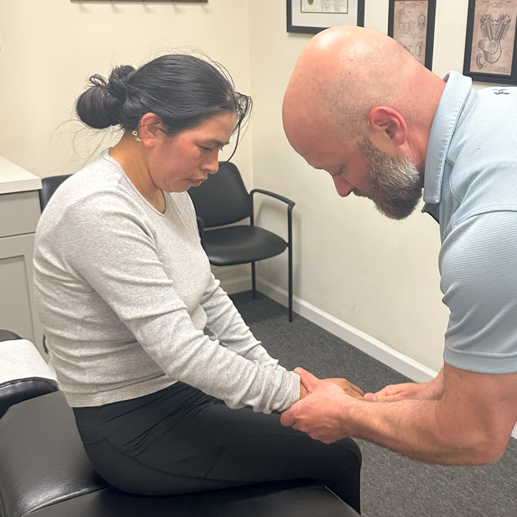 Dr Eric Chludzinski giving her a arm massage