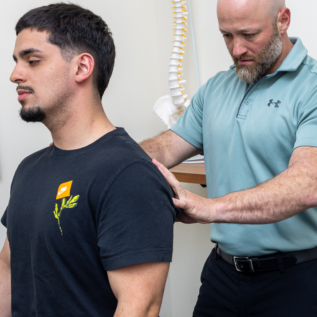 Dr Eric Chludzinski giving his patient a sciatica treatment